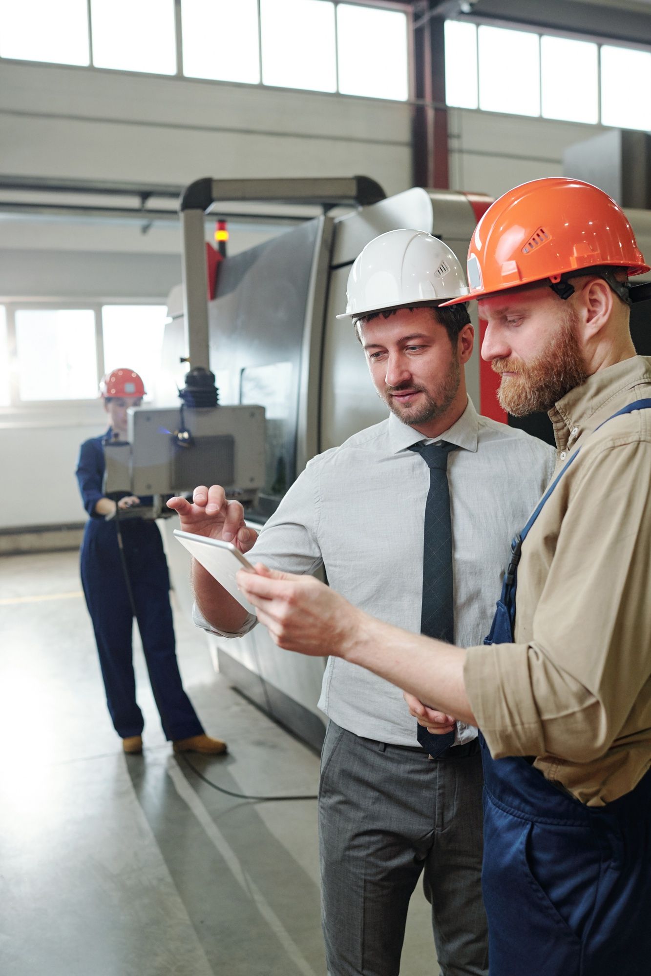 Workers inspecting a press